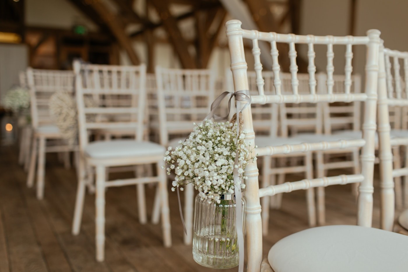Gypsophila posies hung from ceremony chairs