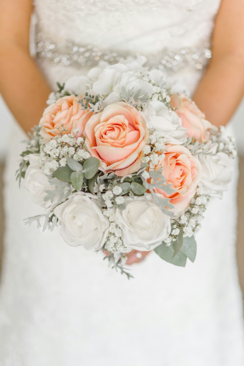 A bridal bouquet of peach and cream roses